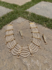 Jadau Kundan haar with six pearl strands and matching drop earrings